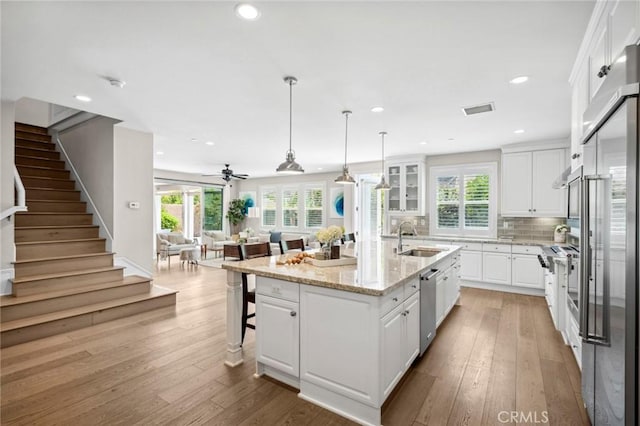 108 Sideways, Irvine, CA 92618 - kitchen with dishwasher, open floor plan, white cabinetry, healthy amount of natural light, and recessed lighting