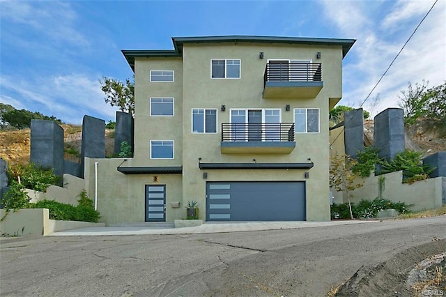 3610 Kinney St, Los Angeles, CA 90065 - view of front facade with a balcony, a garage, and stucco siding