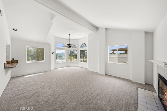 40661 Via Amapola, Murrieta, CA 92562 - unfurnished living room with a tile fireplace, plenty of natural light, carpet flooring, ceiling fan, and beam ceiling