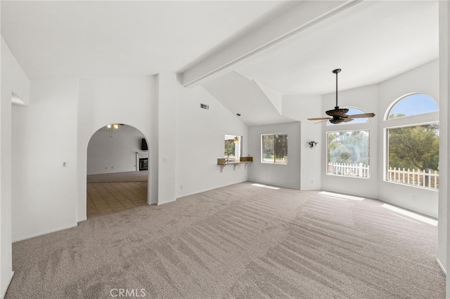40661 Via Amapola, Murrieta, CA 92562 - unfurnished living room with ceiling fan, beamed ceiling, carpet, arched walkways, and high vaulted ceiling