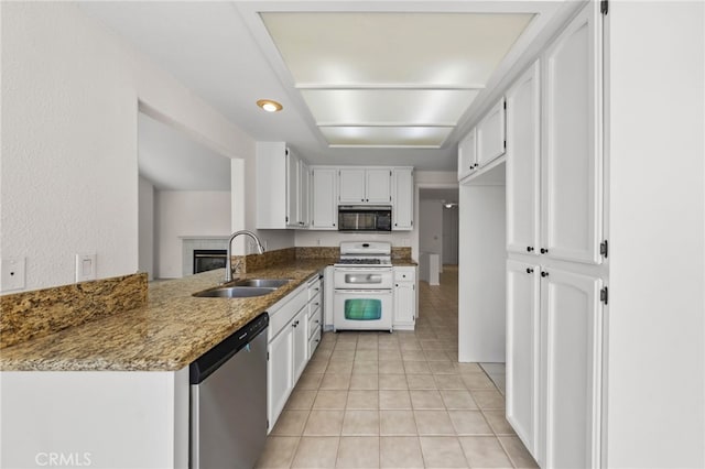 40661 Via Amapola, Murrieta, CA 92562 - kitchen with range with two ovens, black microwave, stainless steel dishwasher, a sink, and white cabinets