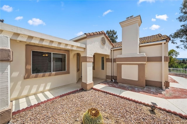 40661 Via Amapola, Murrieta, CA 92562 - view of front facade with a tiled roof, stucco siding, and a chimney