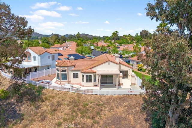 40661 Via Amapola, Murrieta, CA 92562 - rear view of house with a fenced backyard, a patio area, a mountain view, and stucco siding