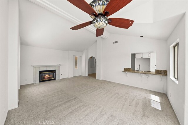 40661 Via Amapola, Murrieta, CA 92562 - unfurnished living room with carpet flooring, a ceiling fan, a fireplace, baseboards, and a sink