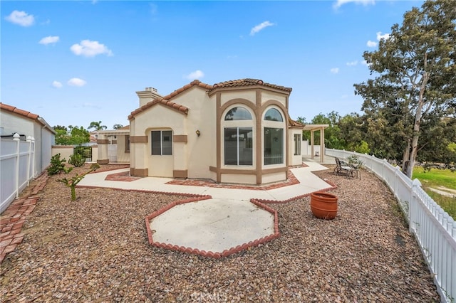 40661 Via Amapola, Murrieta, CA 92562 - back of house with a chimney, stucco siding, a patio, a tiled roof, and a fenced backyard