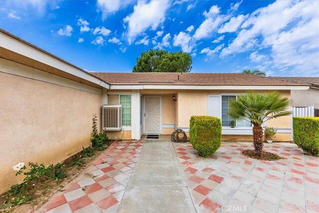 162 Peppertree Way, San Jacinto, CA 92583 - view of exterior entry with stucco siding and a patio area