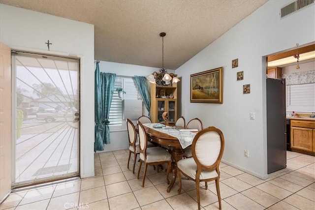 162 Peppertree Way, San Jacinto, CA 92583 - dining area with lofted ceiling, light tile patterned floors, a textured ceiling, and a chandelier
