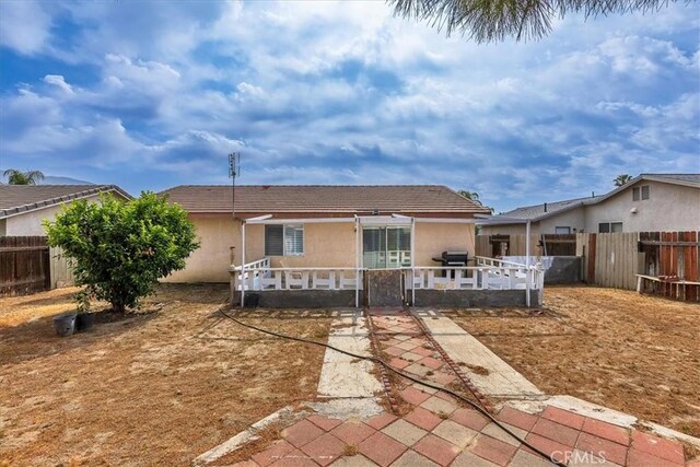 162 Peppertree Way, San Jacinto, CA 92583 - back of property with a fenced backyard, a patio area, and stucco siding