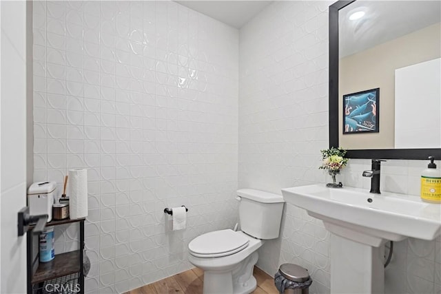 7436 Royal St, Buena Park, CA 90620 - bathroom with tile walls, toilet, wood finished floors, and a sink