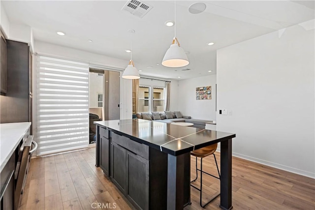 7436 Royal St, Buena Park, CA 90620 - kitchen with a kitchen breakfast bar, wood-type flooring, a kitchen island, pendant lighting, and open floor plan