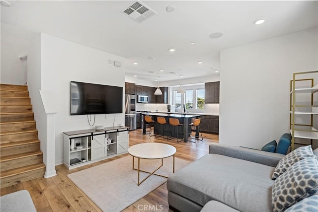 7436 Royal St, Buena Park, CA 90620 - living area featuring light wood-type flooring, stairs, and recessed lighting
