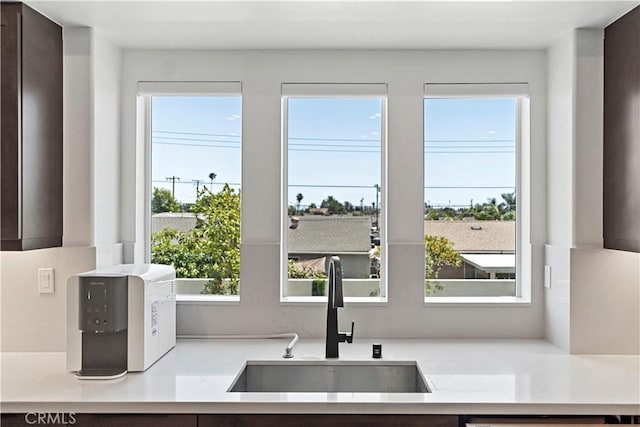 7436 Royal St, Buena Park, CA 90620 - kitchen with a sink, dark brown cabinets, and light countertops