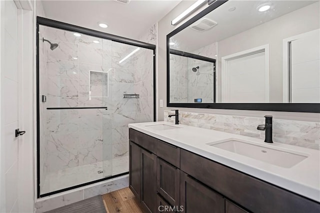 7436 Royal St, Buena Park, CA 90620 - bathroom with a marble finish shower, wood finished floors, double vanity, and recessed lighting
