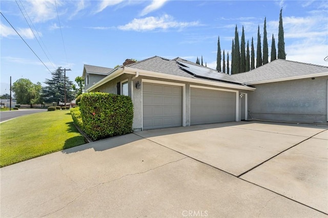 1270 Belle Rd, Calimesa, CA 92320 - view of front of home featuring a garage, solar panels, stucco siding, a front yard, and concrete driveway