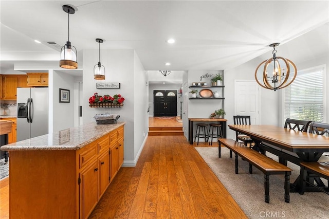 1270 Belle Rd, Calimesa, CA 92320 - kitchen featuring stainless steel fridge, a chandelier, hardwood / wood-style floors, brown cabinetry, and decorative light fixtures