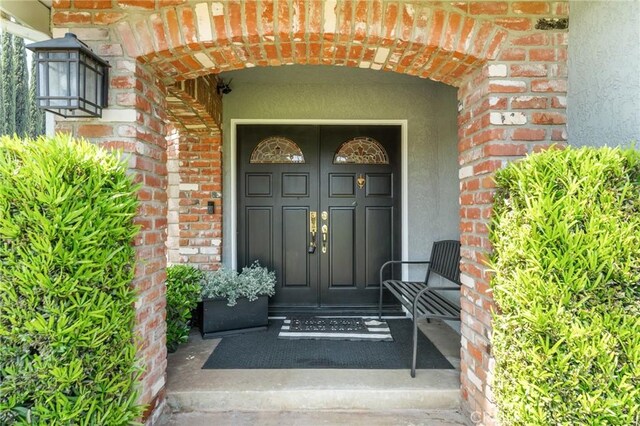 1270 Belle Rd, Calimesa, CA 92320 - view of exterior entry with brick siding and stucco siding