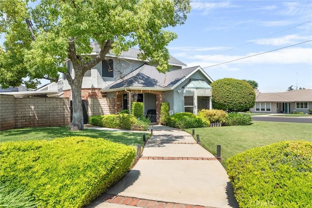 1270 Belle Rd, Calimesa, CA 92320 - view of front of home with a front yard, a shingled roof, and brick siding