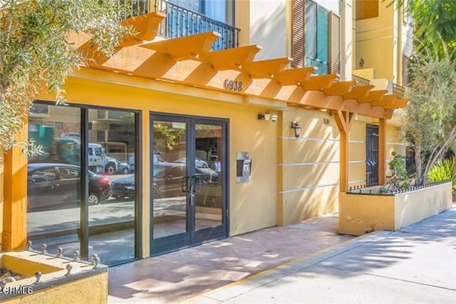 6938 Laurel Canyon Blvd Unit 214, North Hollywood, CA 91605 - property entrance featuring a balcony and stucco siding