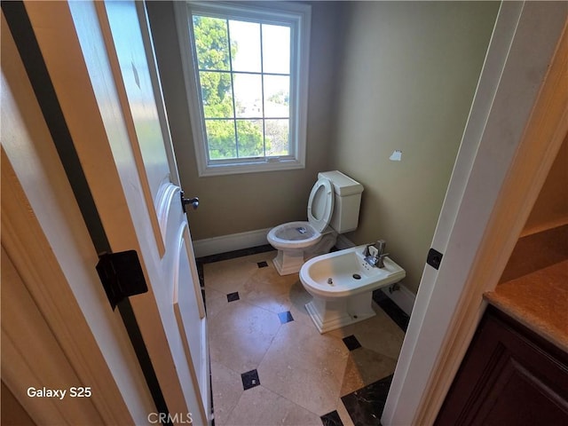 10040 Mattock Ave, Downey, CA 90240 - half bathroom with toilet, a bidet, baseboards, and vanity