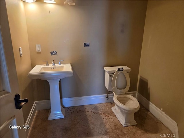 10040 Mattock Ave, Downey, CA 90240 - half bath featuring toilet, baseboards, tile patterned floors, and a sink