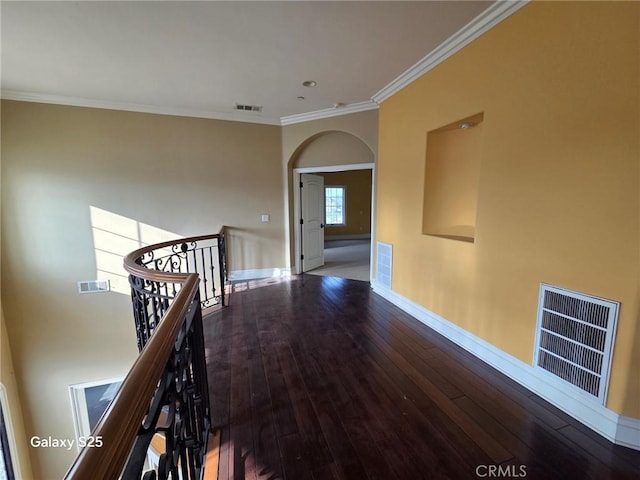 10040 Mattock Ave, Downey, CA 90240 - hallway featuring an upstairs landing, crown molding, baseboards, wood-type flooring, and arched walkways
