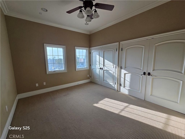 10040 Mattock Ave, Downey, CA 90240 - unfurnished bedroom with light carpet, baseboards, crown molding, ceiling fan, and two closets