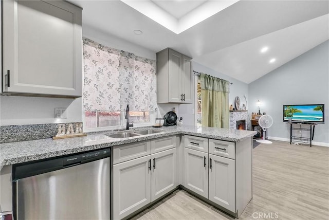 1264 N Mulberry Ave, Rialto, CA 92376 - kitchen with dishwasher, a peninsula, light wood-type flooring, light stone countertops, and a warm lit fireplace
