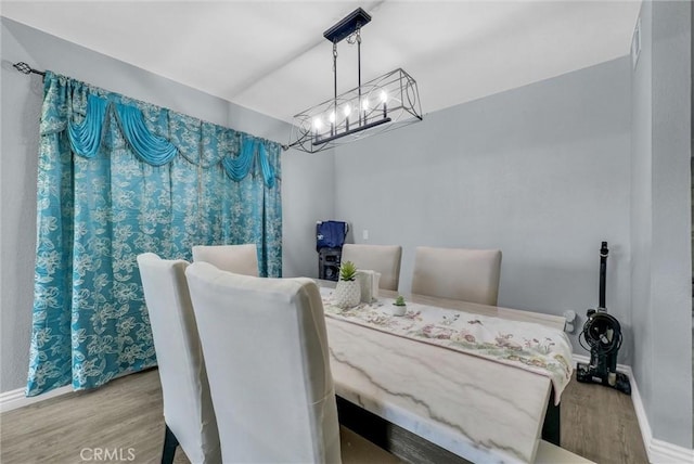 1264 N Mulberry Ave, Rialto, CA 92376 - dining area featuring wood finished floors and a chandelier