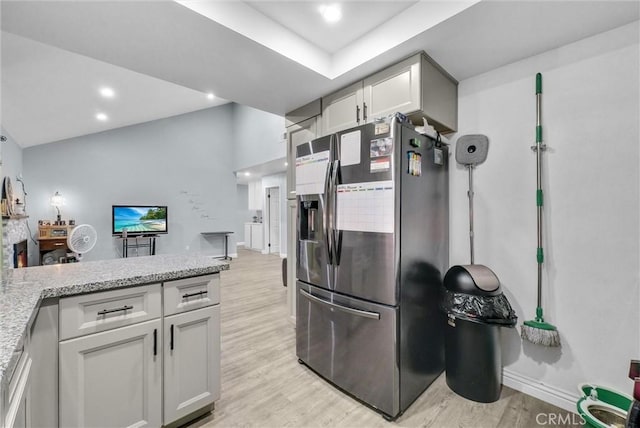 1264 N Mulberry Ave, Rialto, CA 92376 - kitchen with stainless steel fridge, light wood-style floors, recessed lighting, white cabinetry, and light stone counters
