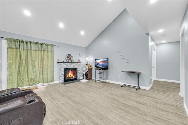 1264 N Mulberry Ave, Rialto, CA 92376 - living room featuring light wood-style floors, a stone fireplace, recessed lighting, and high vaulted ceiling