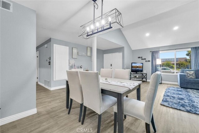 1264 N Mulberry Ave, Rialto, CA 92376 - dining area featuring wood finished floors, a chandelier, and lofted ceiling
