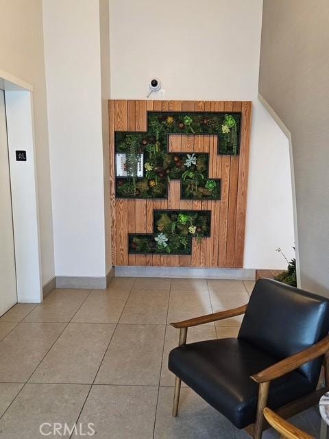 2620 2nd Ave Unit 5B, San Diego, CA 92103 - living room with tile patterned flooring, elevator, and baseboards