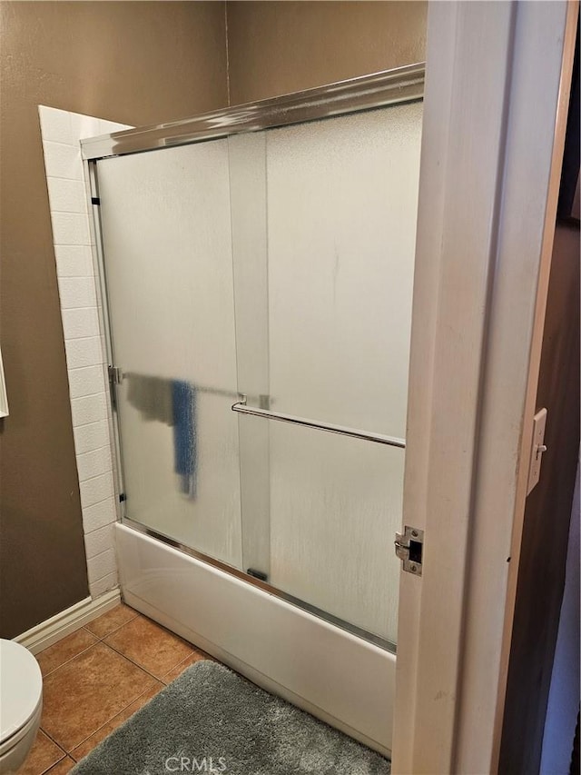 2620 2nd Ave Unit 5B, San Diego, CA 92103 - full bath featuring toilet, shower / bath combination with glass door, tile patterned flooring, and baseboards