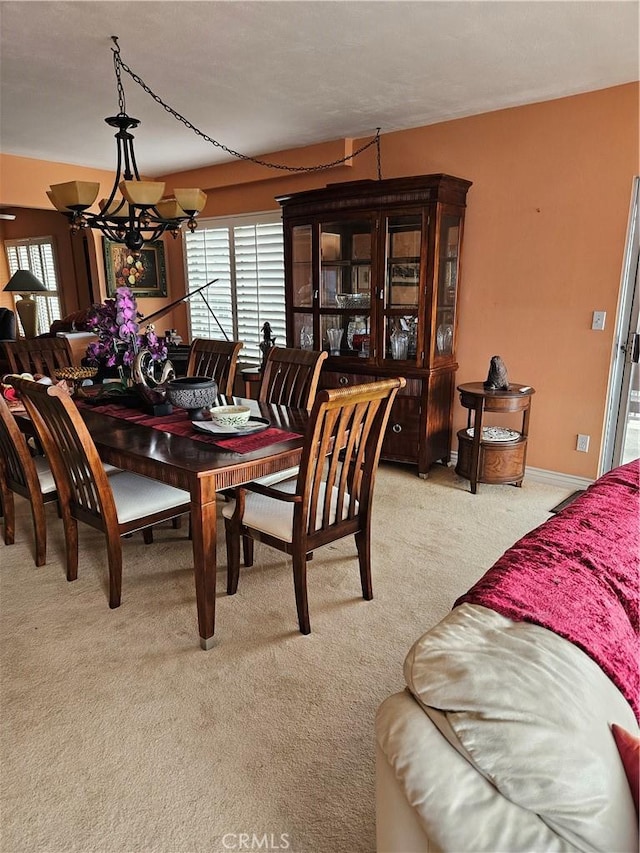 2620 2nd Ave Unit 5B, San Diego, CA 92103 - dining room featuring a chandelier, light colored carpet, and plenty of natural light