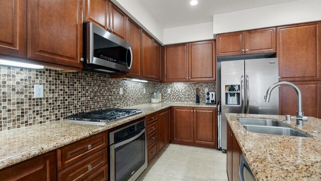 2510 Aperture Cir, San Diego, CA 92108 - kitchen with appliances with stainless steel finishes, a sink, light stone counters, and decorative backsplash