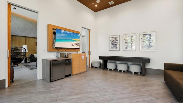 2510 Aperture Cir, San Diego, CA 92108 - living room with a high ceiling and light wood-style flooring