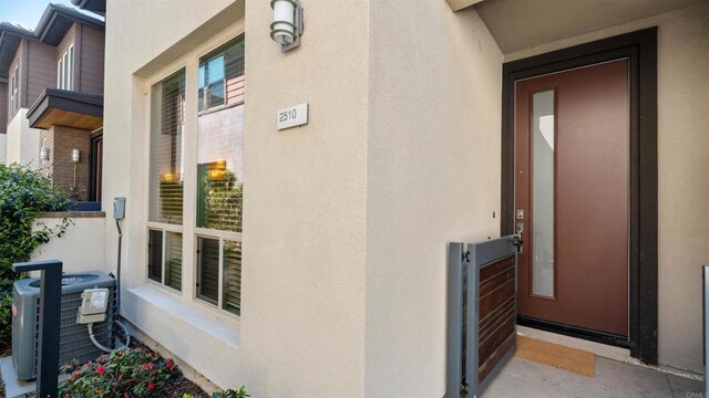 2510 Aperture Cir, San Diego, CA 92108 - doorway to property featuring central air condition unit and stucco siding