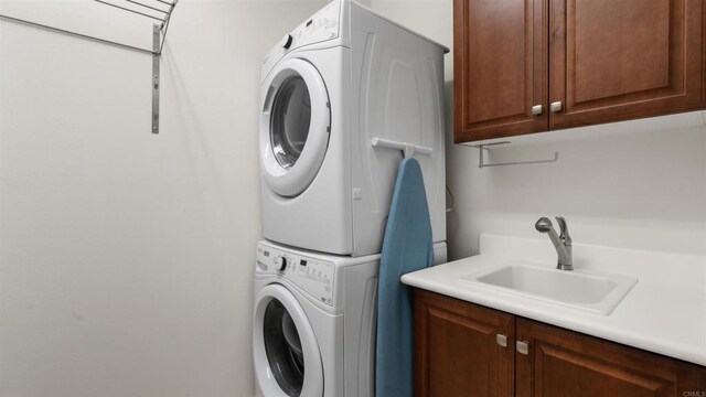 2510 Aperture Cir, San Diego, CA 92108 - laundry area featuring stacked washer and clothes dryer and cabinet space