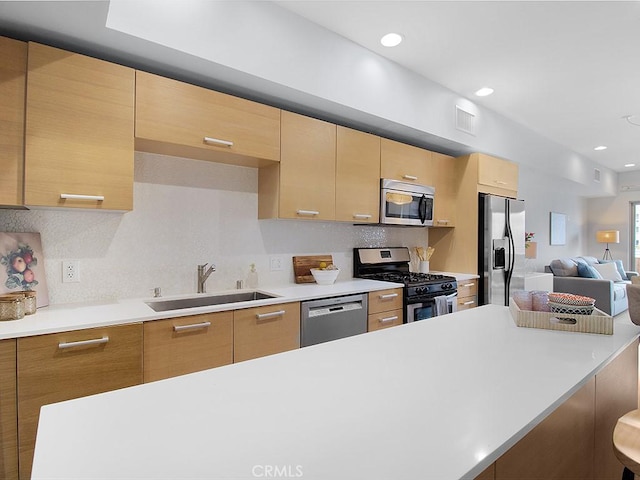 5016 Bakman Ave Unit 304, North Hollywood, CA 91601 - kitchen featuring a sink, appliances with stainless steel finishes, light countertops, decorative backsplash, and recessed lighting