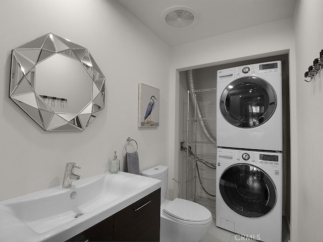 5016 Bakman Ave Unit 304, North Hollywood, CA 91601 - bathroom featuring stacked washer and clothes dryer, toilet, and vanity