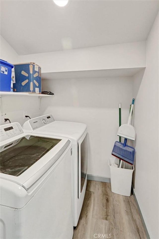 30396 Live Oak Dr, Running Springs, CA 92382 - laundry area featuring independent washer and dryer, light wood-style flooring, and baseboards