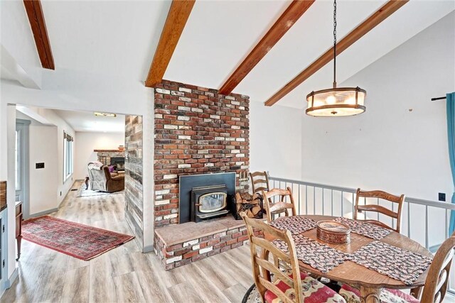 30396 Live Oak Dr, Running Springs, CA 92382 - dining space featuring wood finished floors, a wood stove, and a brick fireplace