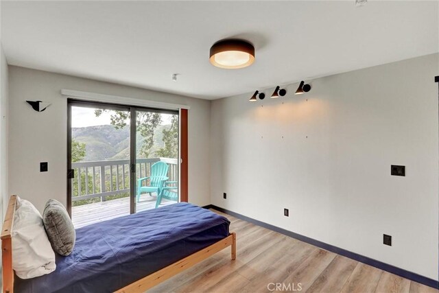 30396 Live Oak Dr, Running Springs, CA 92382 - bedroom with access to outside, light wood-style flooring, and baseboards