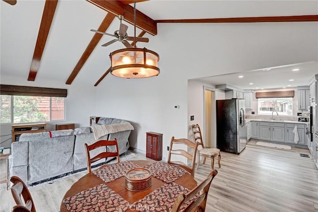 30396 Live Oak Dr, Running Springs, CA 92382 - dining area featuring ceiling fan, healthy amount of natural light, beamed ceiling, light wood-style flooring, and high vaulted ceiling