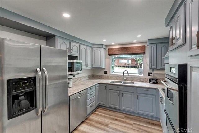 30396 Live Oak Dr, Running Springs, CA 92382 - kitchen with appliances with stainless steel finishes, a sink, gray cabinetry, light wood-type flooring, and recessed lighting