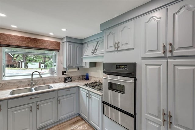 30396 Live Oak Dr, Running Springs, CA 92382 - kitchen featuring stainless steel appliances, a warming drawer, a sink, gray cabinetry, and light countertops