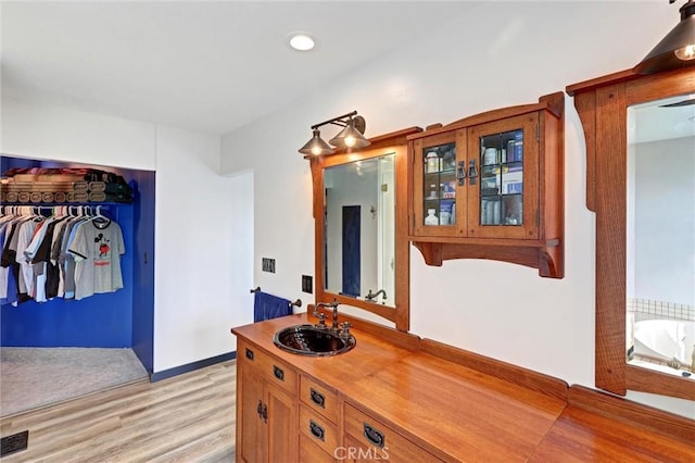 30396 Live Oak Dr, Running Springs, CA 92382 - hallway featuring a sink, light wood-style flooring, recessed lighting, and baseboards