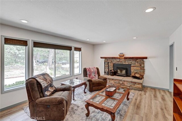 30396 Live Oak Dr, Running Springs, CA 92382 - living area with plenty of natural light, a wood stove, light wood finished floors, baseboards, and recessed lighting