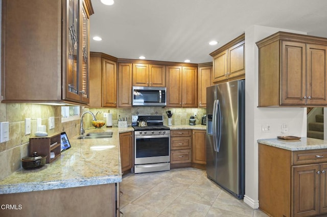 5084 Via Calderon, Camarillo, CA 93012 - kitchen with stainless steel appliances, a sink, brown cabinets, and recessed lighting