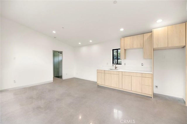 6218 Farrelo Rd, Yucca Valley, CA 92284 - kitchen featuring light brown cabinets, elevator, concrete flooring, a sink, and recessed lighting